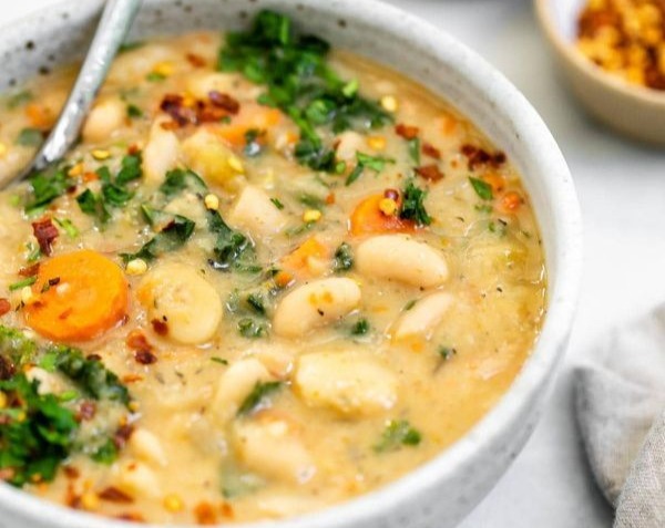 Hearty Vegan Tuscan White Bean Soup with Spinach and Herbs top view